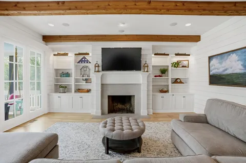 a kitchen with stainless steel appliances kitchen island granite countertop a table chairs and a refrigerator