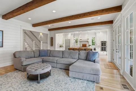 a large kitchen with kitchen island granite countertop lots of counter space and stainless steel appliances