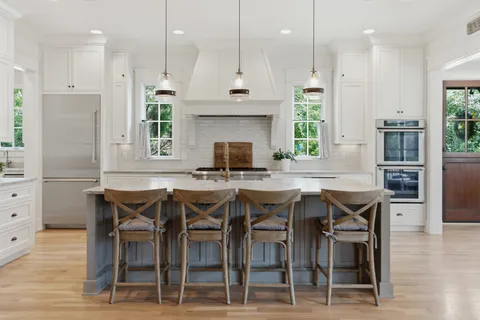 a kitchen with stainless steel appliances granite countertop a stove and a wooden floors
