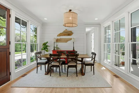a dining room with furniture a chandelier and window