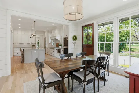 a dining room with furniture a window and a chandelier