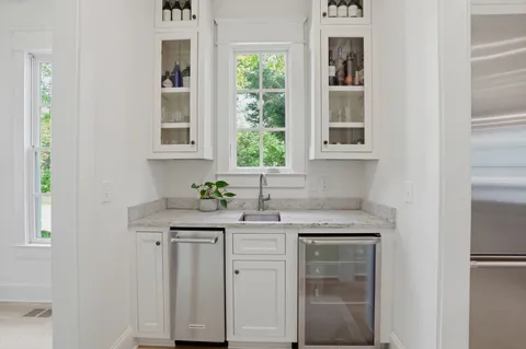 a living room with a bed furniture and a large window