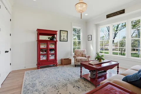 a bathroom with a toilet sink vanity granite and mirror