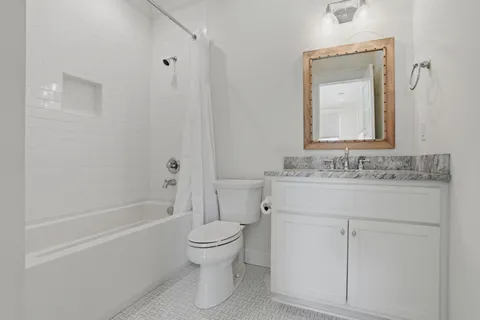 a living room with furniture and a ceiling fan
