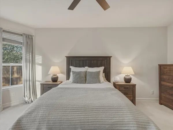 a spacious bedroom with a bed and large window
