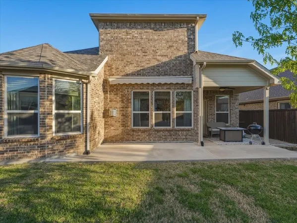 a view of a house with a yard and sitting area
