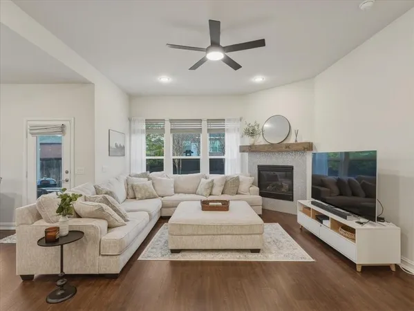 a living room with furniture a flat screen tv and a fireplace