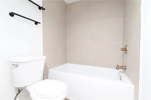 a white toilet sitting next to a bathroom sink