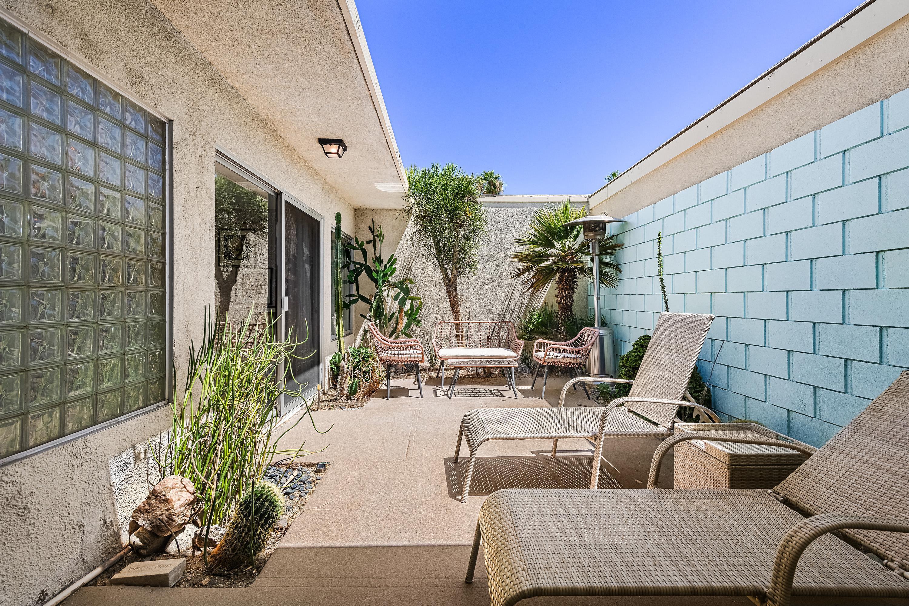 1855 Ramon Road, Unit 14 Palm Springs, CA 92264 - Photo 21 of 34 a view of a chairs and table in the patio