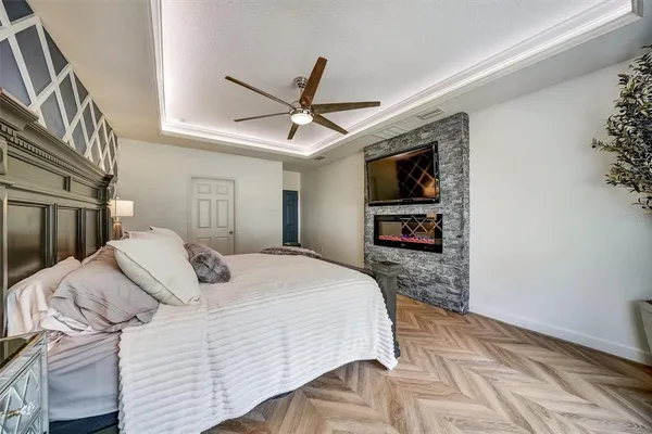 a spacious bathroom with a granite countertop sink a toilet a mirror and bathtub