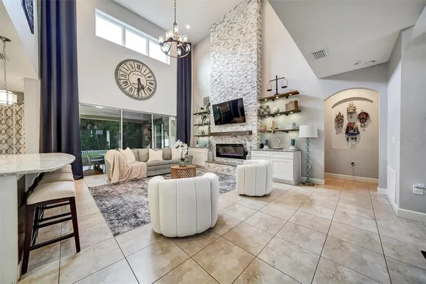 a living room with fireplace furniture and a window