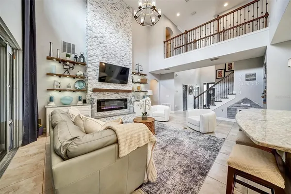 a living room with furniture a flat screen tv and a fireplace