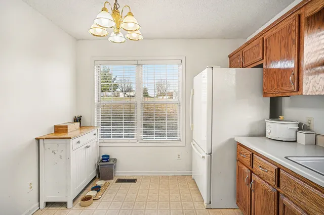 a kitchen with a refrigerator a sink and cabinets