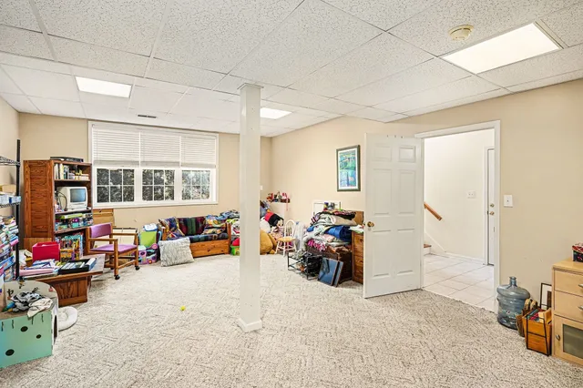 a view of a livingroom with furniture and a window