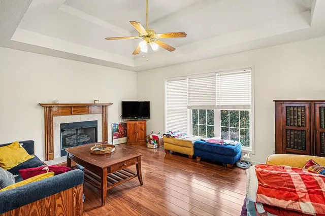 a living room with furniture a flat screen tv and a fireplace