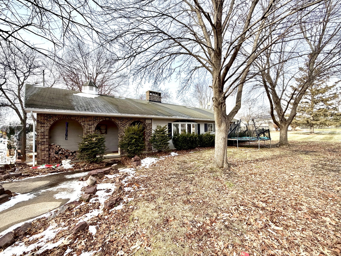 a view of house with snow on the road