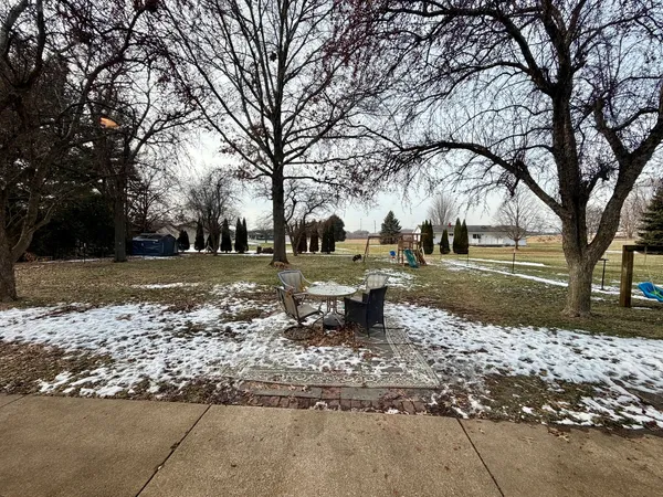 a view of a fire pit with large trees