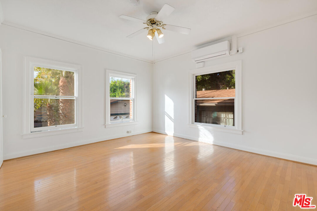 5121 1/2 Eagle Rock Boulevard, Unit E Los Angeles, CA 90065 - Photo 1 of 14 a view of an empty room with a window and wooden floor