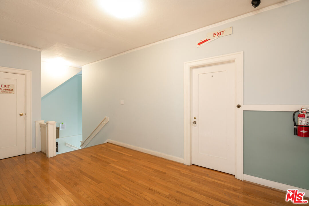 5121 1/2 Eagle Rock Boulevard, Unit E Los Angeles, CA 90065 - Photo 11 of 14 a bedroom with a bed and wooden floor