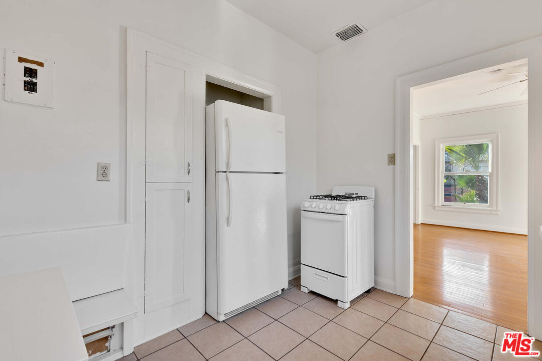 5121 1/2 Eagle Rock Boulevard, Unit E Los Angeles, CA 90065 - Photo 7 of 14 a utility room with cabinets washer and dryer