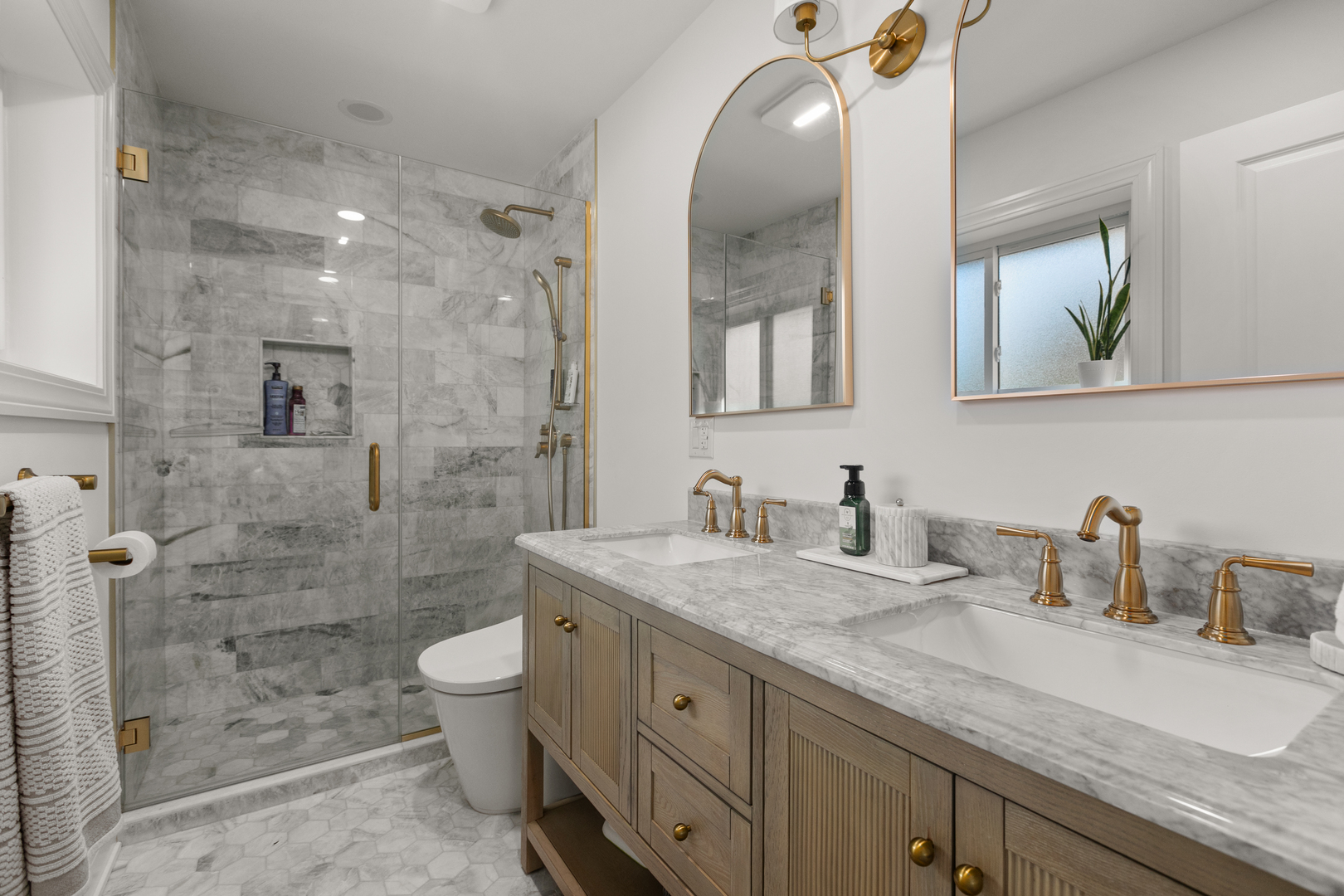 1349 Tinker Way Glenview, IL 60025 - Photo 21 of 42 a bathroom with a granite countertop sink a toilet a mirror and shower