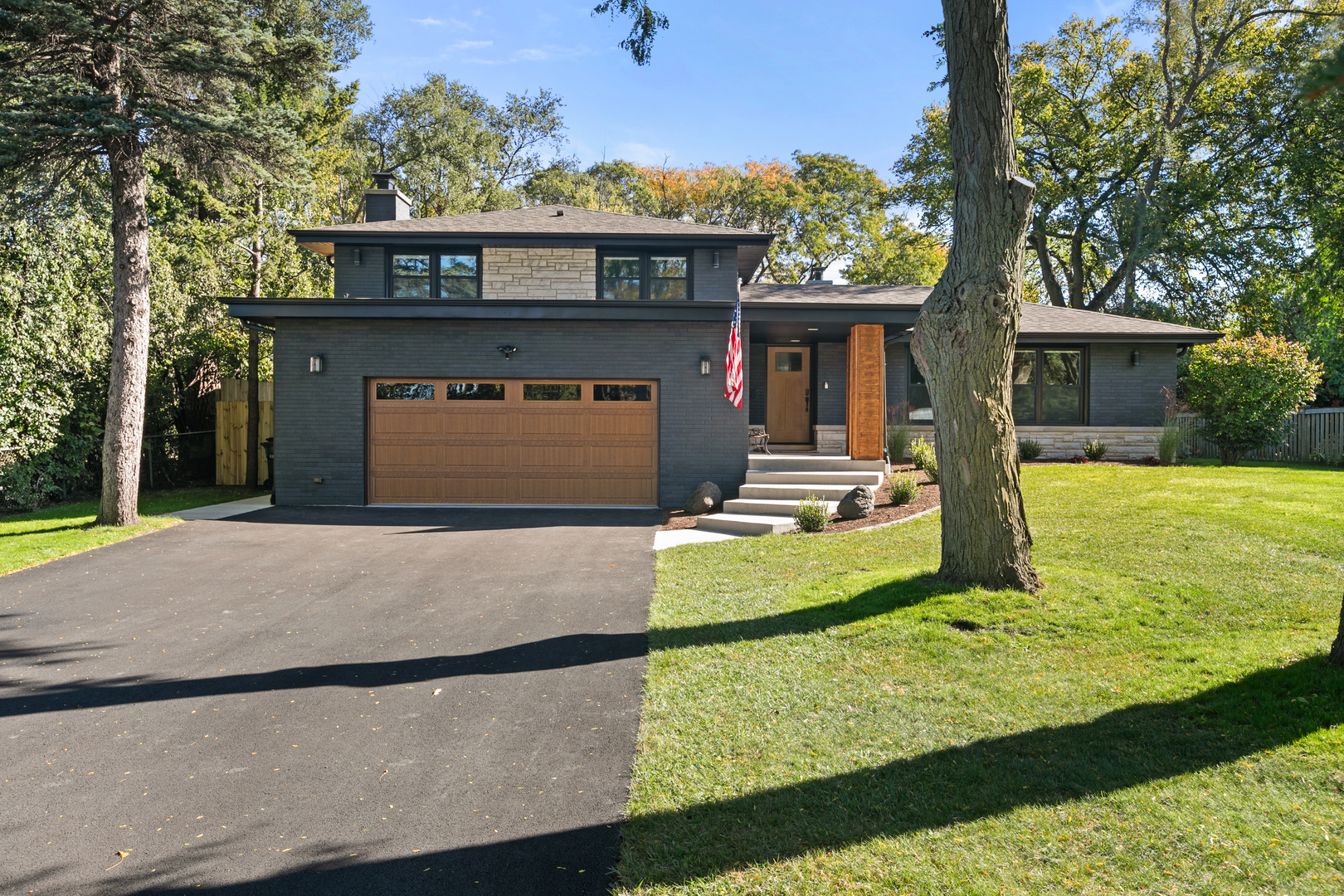 1349 Tinker Way Glenview, IL 60025 - Photo 3 of 42 a front view of a house with garden