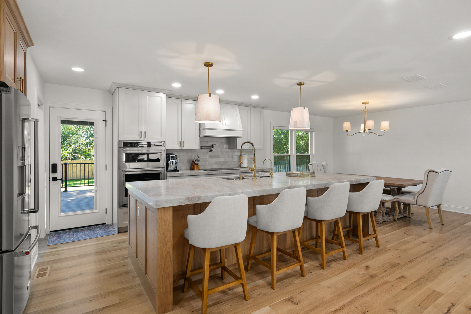 1349 Tinker Way Glenview, IL 60025 - Photo 7 of 42 a kitchen with a dining table chairs wooden floor appliances and cabinets
