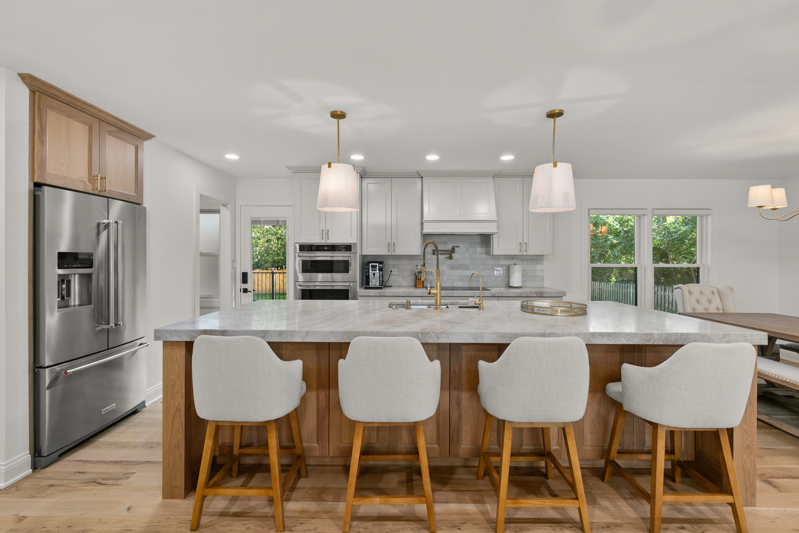 1349 Tinker Way Glenview, IL 60025 - Photo 8 of 42 a kitchen with stainless steel appliances granite countertop a dining table chairs refrigerator and sink
