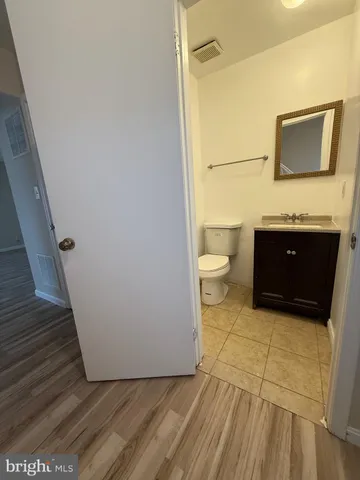 a bathroom with a sink a toilet and mirror