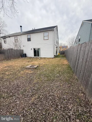 a view of backyard of house and car parked