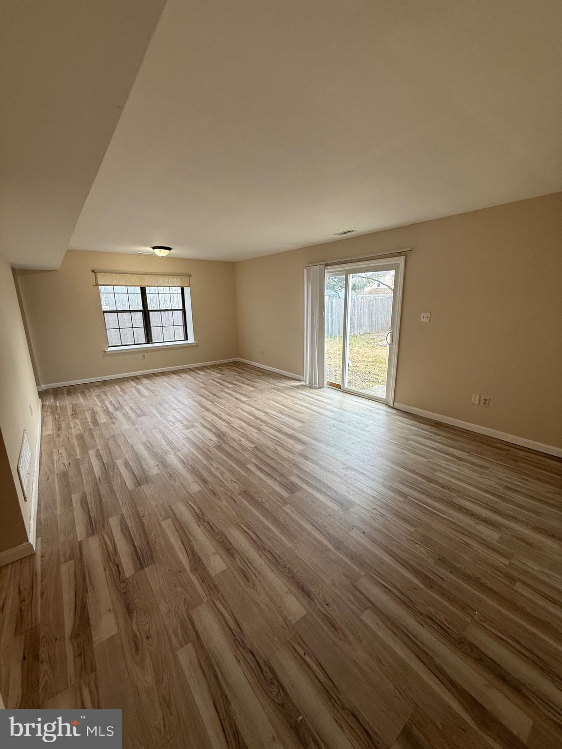 8 Hewitt Lane Sicklerville, NJ 08081 - Photo 3 of 15 an empty room with wooden floor and windows