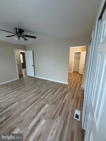 a view of a room with wooden floor and staircase