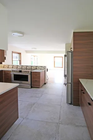 a large kitchen with cabinets and stainless steel appliances