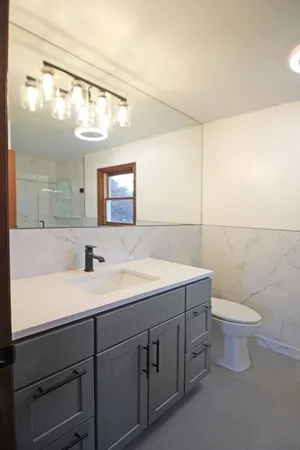 a bathroom with a glass shower door