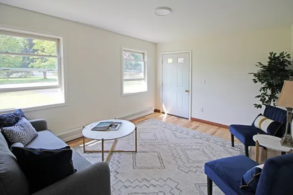 a living room with furniture and wooden floor
