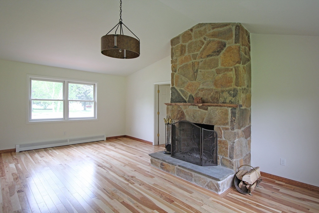 30-a & B Lee Road South Deerfield, MA 01373 - Photo 4 of 39 an empty room with wooden floor fireplace and windows