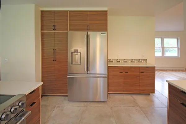 a kitchen with a refrigerator and a stove