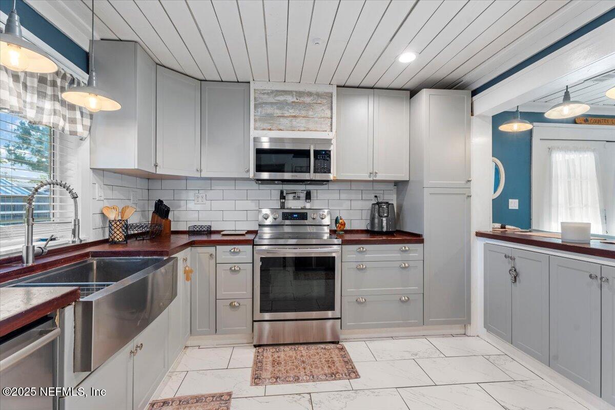6582 Hamilton Crews Road Glen St. Mary, FL 32040 - Photo 17 of 44 a kitchen with stainless steel appliances granite countertop a sink a stove and cabinets