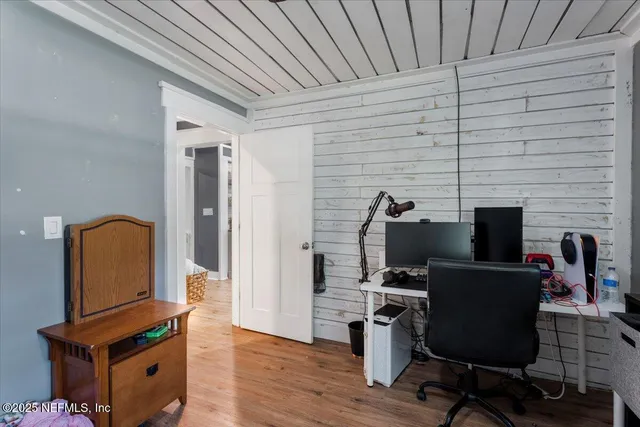 a view of workspace with wooden floor windows
