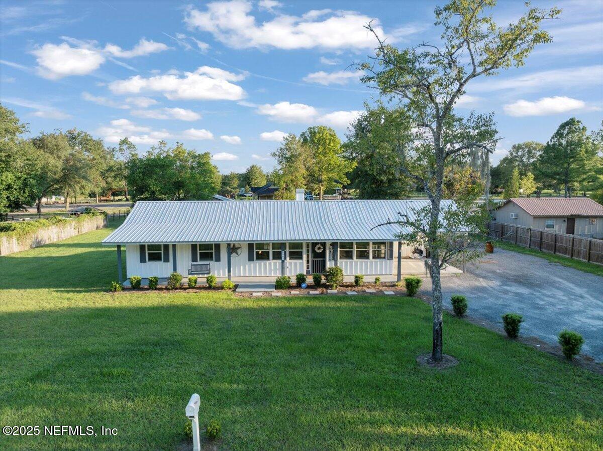6582 Hamilton Crews Road Glen St. Mary, FL 32040 - Photo 2 of 44 a front view of a house with garden