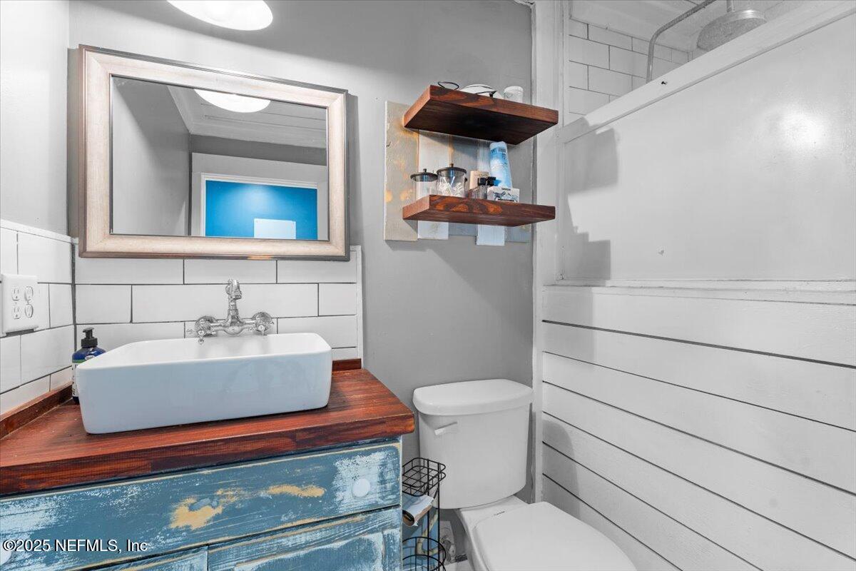 6582 Hamilton Crews Road Glen St. Mary, FL 32040 - Photo 27 of 44 a bathroom with a sink a toilet and mirror