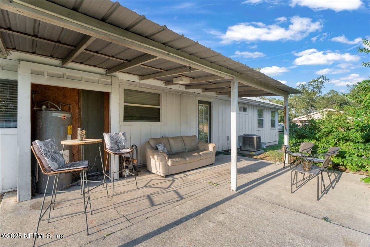 6582 Hamilton Crews Road Glen St. Mary, FL 32040 - Photo 28 of 44 a view of a patio with couches chairs and potted plants