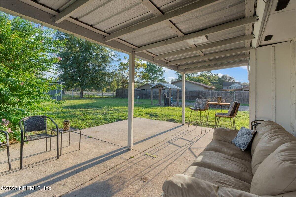 6582 Hamilton Crews Road Glen St. Mary, FL 32040 - Photo 37 of 44 a view of a porch with furniture and a yard