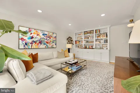 a living room with furniture fireplace and rug