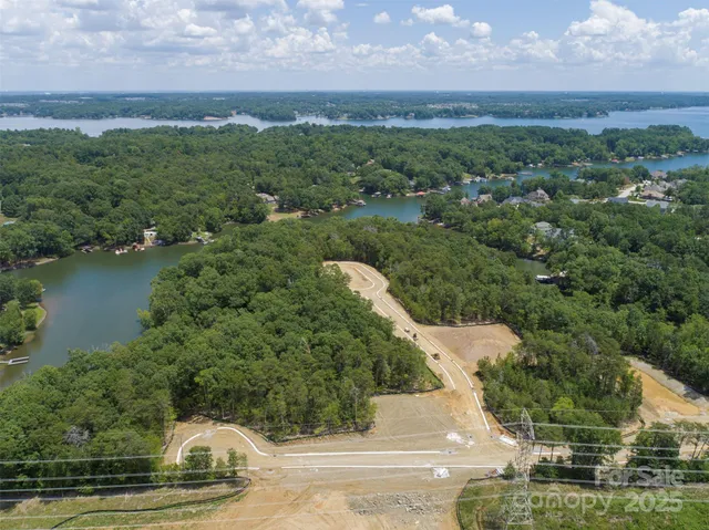 an aerial view of a house with a yard and lake view