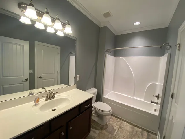 a bathroom with a double vanity sink toilet and shower