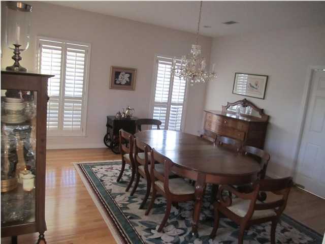 8244 Jordan Road Baker, FL 32531 - Photo 19 of 32 a dining room with furniture a chandelier and wooden floor