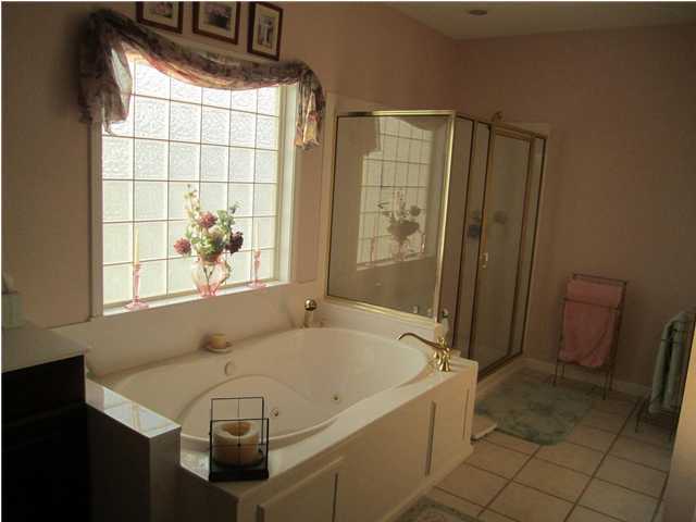 8244 Jordan Road Baker, FL 32531 - Photo 28 of 32 a bathroom with a tub a sink and a shower