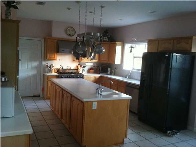 8244 Jordan Road Baker, FL 32531 - Photo 30 of 32 a kitchen with stainless steel appliances granite countertop a sink a refrigerator and a stove