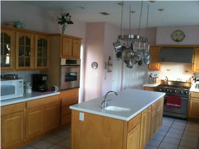 8244 Jordan Road Baker, FL 32531 - Photo 32 of 32 a kitchen with a sink a stove and cabinets